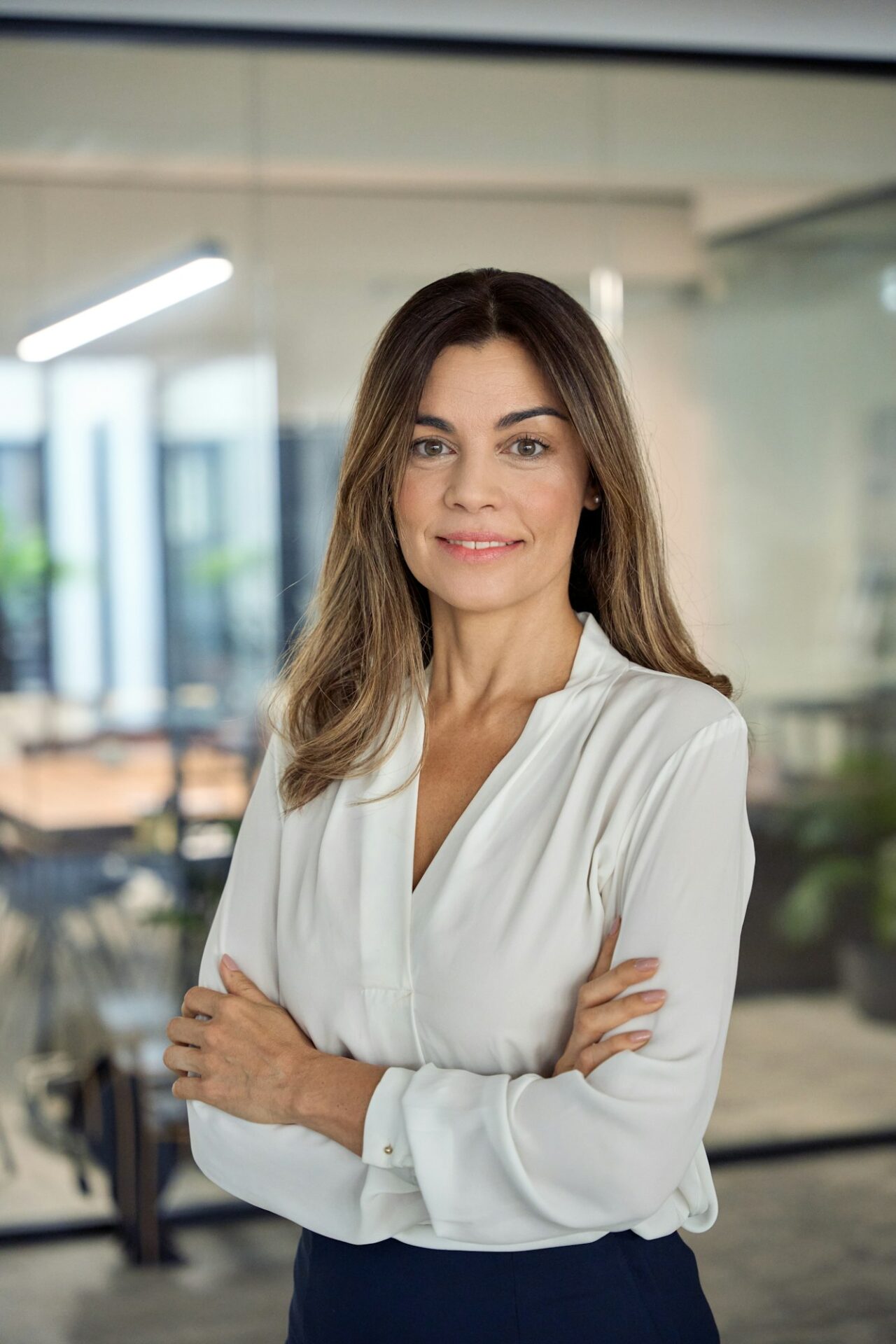 Smiling confident Latin professional mature business woman in office, portrait.